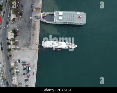 aerial view luxury yach ouranos and speed boat anchored beside of corfu ferry ship in yacht marina port of igoumenitsa city in greece epirus Stock Photo