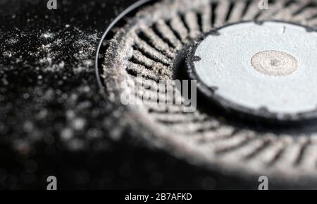 Dusty ventilator fan of an overheated laptop in need of  cleaning Stock Photo