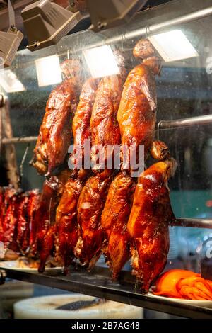 Delicious crispy roast ducks hanging in the display window of Wan Chai Corner restaurant in Chinatown, London, UK Stock Photo