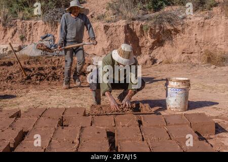 Workmen producing adobes, Otro Mundo, Quebrada de Humahuaca, Quebrada de la Conchas, Chonchas Valley, Argentina, Latin America Stock Photo