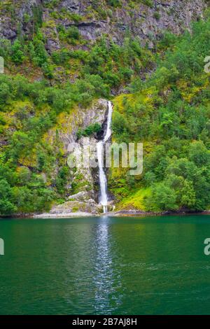 Waterfall at the shore of Aurlandsfjord-branch of Sognefjord on summer day,Vestland county, Norway Stock Photo