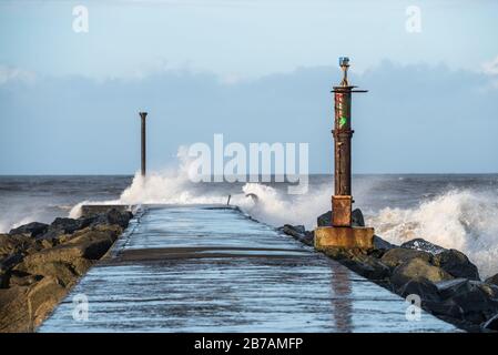 Ocean waves crashing on the end of the Barmouth in Castlerock, Norther Ireland Stock Photo