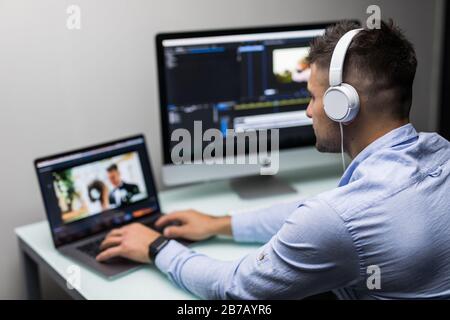 back view of video editor using computer Stock Photo