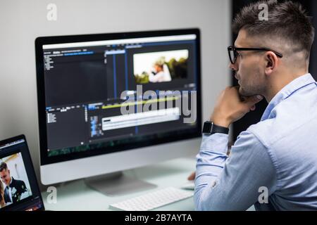 back view of video editor using computer Stock Photo