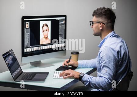 Close-up Of A Designer's Hand Editing Photo On Computer In Office Stock Photo