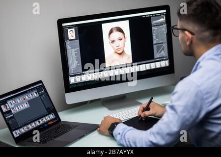 Close-up Of A Designer's Hand Editing Photo On Computer In Office Stock Photo
