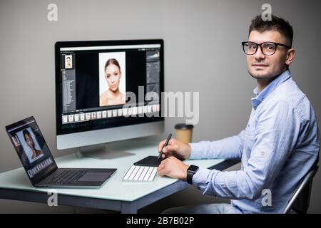 Close-up Of A Designer's Hand Editing Photo On Computer In Office Stock Photo