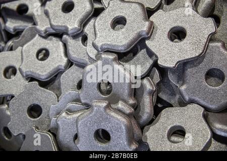 full frame pile of gray steel forgings after shot blasting - close-up natural heavy industrial pattern with selective focus Stock Photo