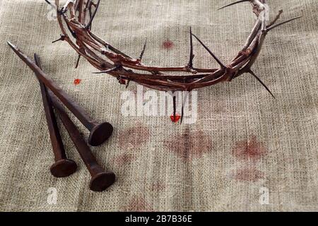 Crown of thorns with nails on textile background. Easter background. Jesus Christ. Stock Photo