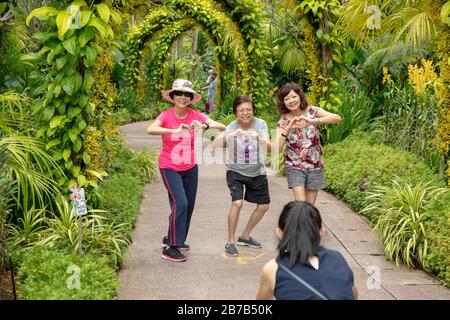 Four senior citizens seen in the National Orchid Garden of Singapore. Stock Photo