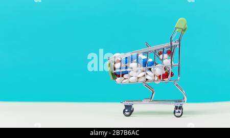 Miniature shopping cart filled with pills, tablets and capsules: pharmacy shopping, medicine and drug abuse concept Stock Photo