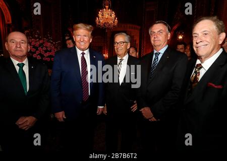 Brazilian President Jair Bolsonaro, 2nd right, and U.S. President Donald Trump, 2nd left, pose with delegation members before a dinner at the Mar a Lago resort March 7, 2020 in Palm Beach, Florida. Stock Photo