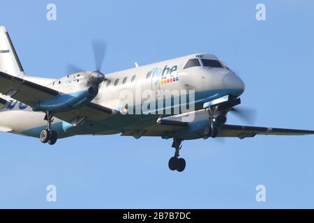 A Flybe aircraft making a landing at Leeds Bradford International Airport Stock Photo