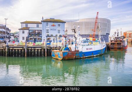 Fishing boat moored at the quay by the Bridge Tavern on Camber Quay (The Camber), the ancient port in Old Portsmouth, Hampshire, south coast England Stock Photo