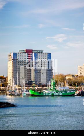 Green lightship Mary Mouse 2 moored at the entrance to Haslar Marina in Portsmouth Harbour viewed from Old Portsmouth, Hampshire, south coast England Stock Photo