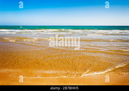 Clean water sandy beach summer background. Summertime ocean backdrop