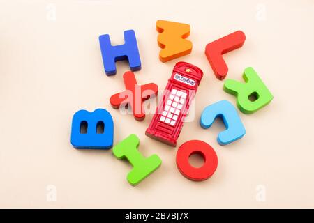 Colorful wooden ABC alphabet letter blocks and British telephone boot Stock Photo