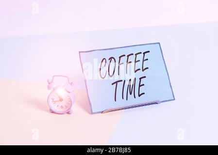 Conceptual hand writing showing Coffee Time. Concept meaning a short period of time in which you stop working to rest Alarm clock beside a Paper sheet Stock Photo