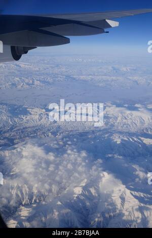 aerial view from plane at snow covered mountains in eastern Turkye Stock Photo