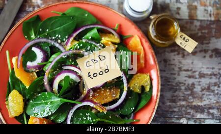 Selective focus. A note with the words cbd food in a plate with salad. The concept of adding CBD oil to food. Cannabis concept. Stock Photo