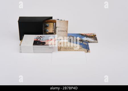 Business card holder and stack of travel photography theme business cards with one blank card for copyspace content Stock Photo