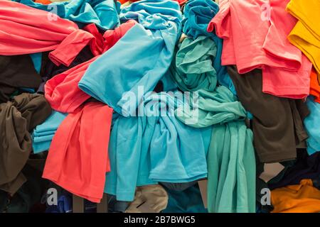 Crowded clearance section in a clothing store, with various