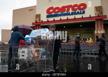 Los Angeles, USA. 14th Mar, 2020. A man pushes a trolley outside a Costco supermarket in Los Angeles, the United States, March 14, 2020. U.S. President Donald Trump on Friday declared a national emergency to open up 50 billion U.S. dollars in federal aid to help combat the spread of COVID-19 across the country. Credit: Qian Weizhong/Xinhua/Alamy Live News Stock Photo