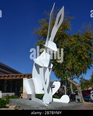 The 26' tall 'One-Eyed-Jack' painted steel jackrabbit sculpture installed in front of Blue Clover Distillery, in old town Scottsdale, USA Stock Photo
