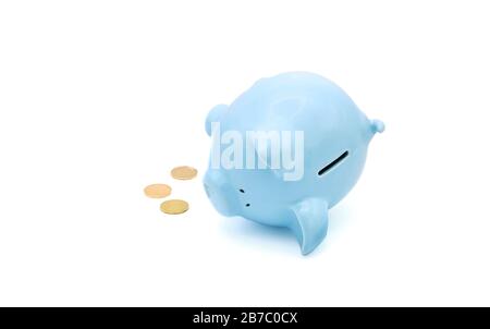 Ceramic piggy bank laying on its side useful for poor or failing economy concept.  White background with ample copy space. Stock Photo