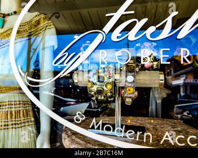 Exotic ethnic bracelets on display through the storefront widow of 'Fashions by Robert', a vintage style boutique in old town Scottsdale, AZ, USA Stock Photo