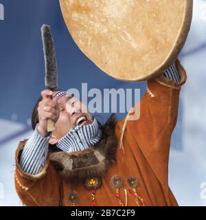 Aboriginal dancer in national clothes of indigenous people dancing with tambourine. Concert Koryak Dance Ensemble Mengo Stock Photo