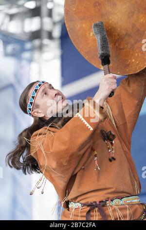 Male dancer in national clothes aborigine people expression dancing with tambourine. Concert Koryak Dance Ensemble Mengo Stock Photo