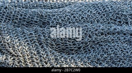 Real handmade chainmail texture close up. Background from metal rings, hauberk.  Stock Photo