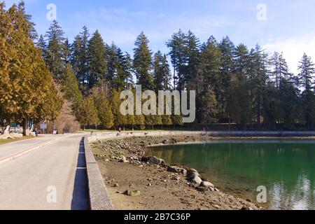 View of seawall path at sunny day in Stanley Park in Vancouver during the low tide Stock Photo