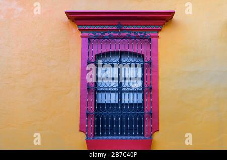 Window with cast iron decoration in the city center of Oaxaca, Mexico. Stock Photo