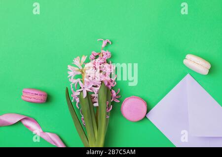 Creative spring flat lay composition with macarons and pink hyacinth flowers Stock Photo