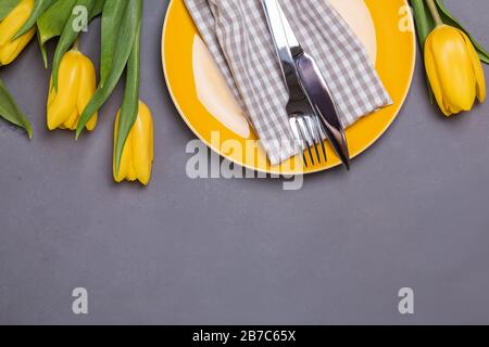 Festive table with yellow tulips. Stock Photo