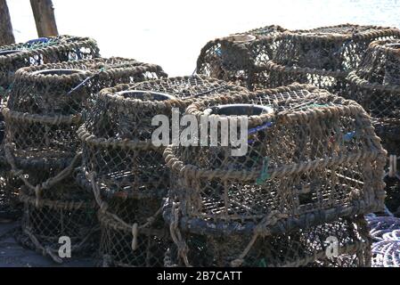 Traditional Lobster Pots on the Harbour Wall in the Fishing Village of Clovelly on the South West Coast Path, North Devon. England, UK. Stock Photo