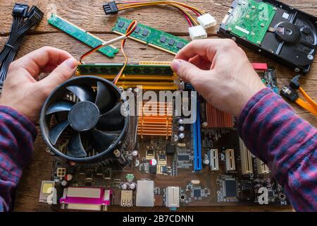 man repairing computer hardware Stock Photo