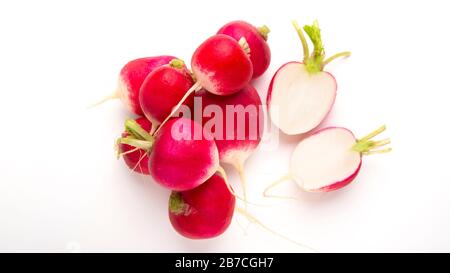 Halved root vegetables and heap of ripe purple radishes Stock Photo