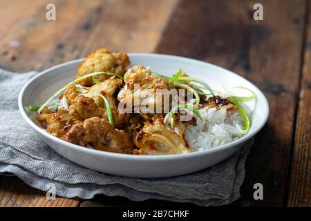 Roast cauliflower with adobo sauce and rice Stock Photo