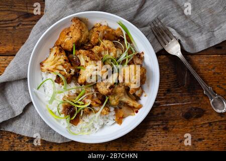 Roast cauliflower with adobo sauce and rice Stock Photo