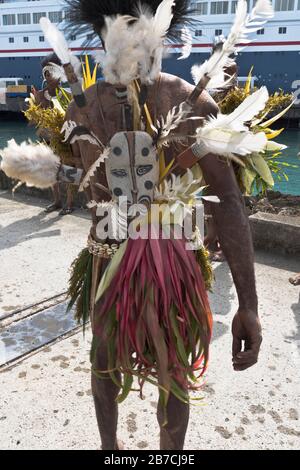 dh Port PNG native welcome WEWAK PAPUA NEW GUINEA Traditional feather tribal dress welcoming cruise ship visitors people touris Stock Photo