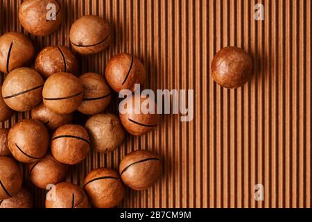 fresh macadam nut close-up on a brown background Stock Photo