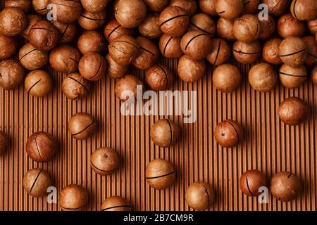 fresh macadam nut close-up on a brown background Stock Photo