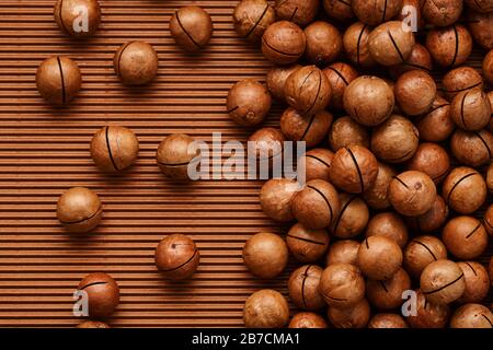 fresh macadam nut close-up on a brown background Stock Photo