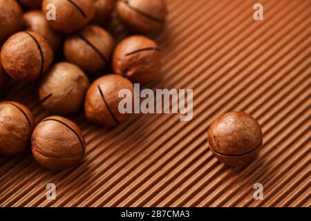 fresh macadam nut close-up on a brown background Stock Photo