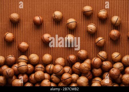 fresh macadam nut close-up on a brown background Stock Photo