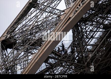 People climbing the stairs to the top of the Eiffel Tower in Paris, France, Europe Stock Photo