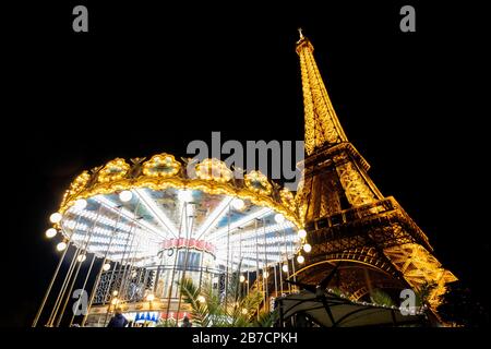 Nighttime view of the old classic carousel outside the Eiffel Tower in Paris, France, Europe Stock Photo